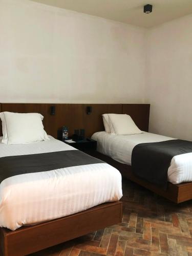 Ένα ή περισσότερα κρεβάτια σε δωμάτιο στο Hotel Marielena