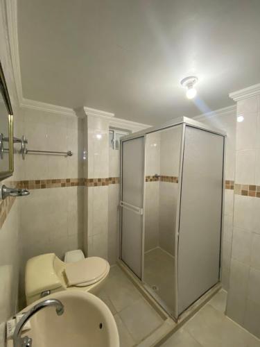 a bathroom with a shower and a toilet and a sink at Hotel Estefanía Princess 84 in Barranquilla