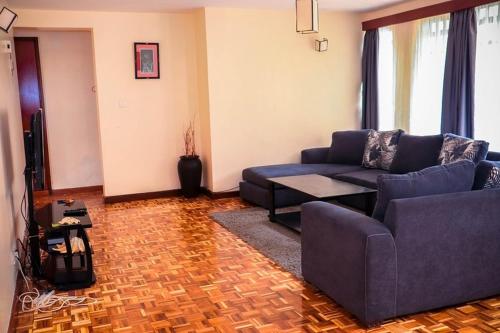 a living room with a couch and a table at Jancy Properties in Nairobi