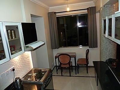 a kitchen with a table and chairs and a window at Jancy Properties in Nairobi