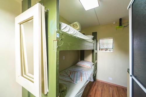 a bunk bed in a tiny house with a window at Hostel Multiverso in Santo André