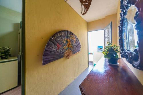 a room with a wall with a fan on the wall at Hostel Multiverso in Santo André
