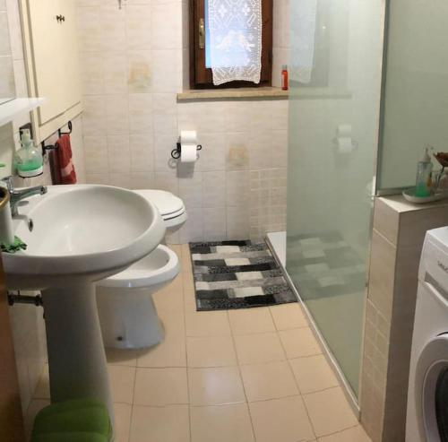 a bathroom with a sink and a toilet and a shower at Al Renaio in Sarteano