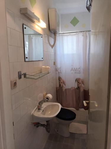 a bathroom with a toilet and a sink at Apartments and rooms by the sea Jelsa, Hvar - 4602 in Jelsa