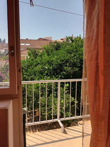 a balcony with a fence and a bush at Apartments and rooms by the sea Jelsa, Hvar - 4602 in Jelsa