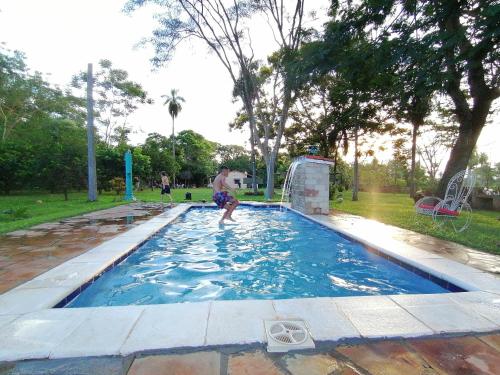 un hombre está jugando en una piscina en Posada Turística Vicenta Aguayo en Yaguarón