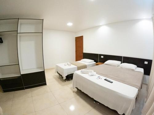 a hotel room with two beds and a mirror at CASA TORRES in Bonito