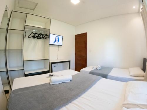 a hotel room with two beds and a mirror at CASA TORRES in Bonito