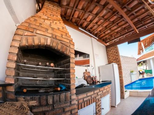 a brick oven in a kitchen with a pool at CASA TORRES in Bonito