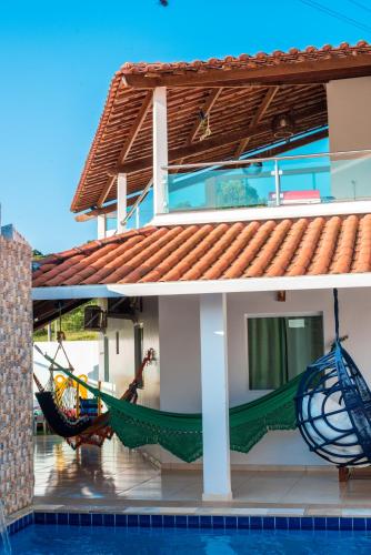 a house with two hammocks on the porch at CASA TORRES in Bonito