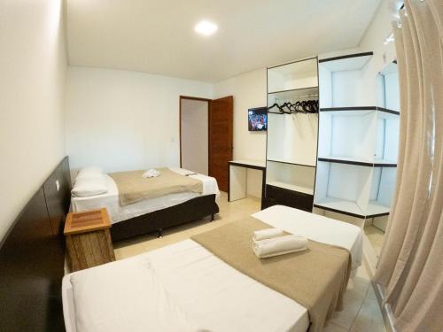 a hotel room with two beds and a mirror at CASA TORRES in Bonito