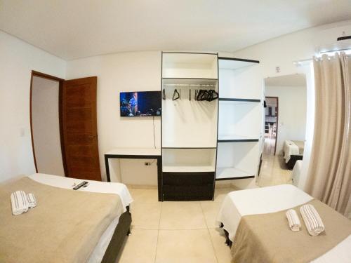 a hotel room with two beds and a mirror at CASA TORRES in Bonito