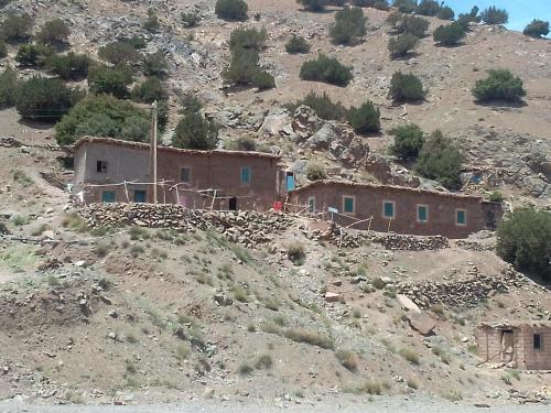 a house on the side of a mountain at Git atlas in Aït Tamellil