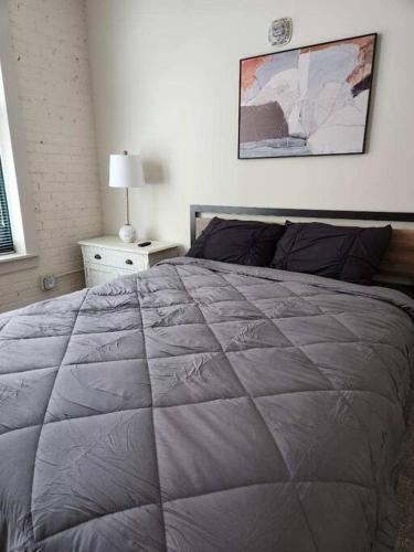a bedroom with a bed with a large quilt at The Best Spot in Downtown St. Louis!! in Saint Louis