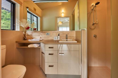 a bathroom with a sink and a toilet and a mirror at Cinnamon House at Vanilla Club in Berner Creek