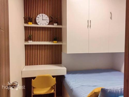 a bedroom with a bed and a clock on a shelf at Happirest at Coast Residences, Pasay - 1 Bedroom with Balcony in Manila