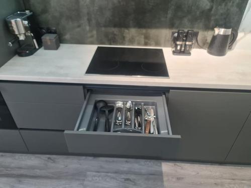 a kitchen counter with a sink and a stove at CityView Apartment in Chişinău