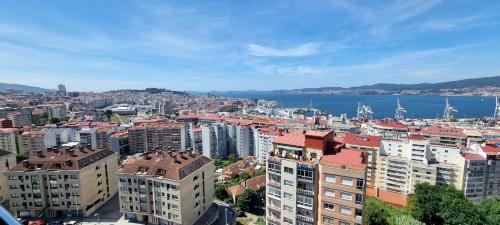 a view of a city with buildings and the water at VistasAragon in Vigo
