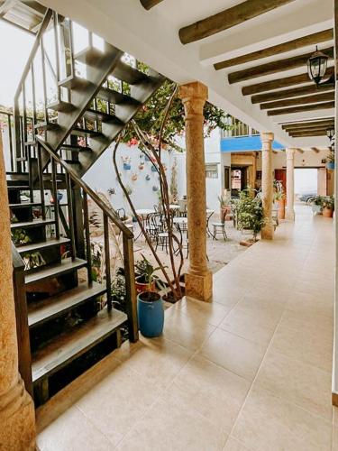 a lobby with a spiral staircase in a building at Hotel Verona Villa de Leyva in Villa de Leyva