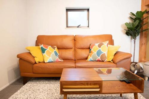 a living room with a couch and a coffee table at 池袋Apila in Tokyo