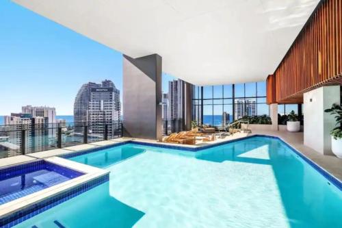 an indoor swimming pool with a view of the city at Casino Residences 1 & 2 Bedroom Apartments in Gold Coast