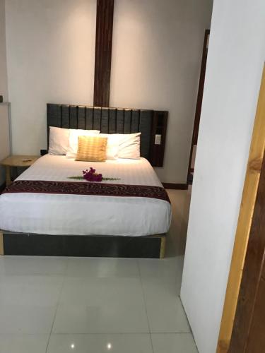 a bedroom with a large bed with flowers on it at Malas Island View in Fulidhoo