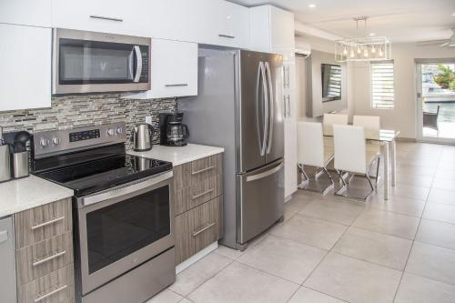 a kitchen with stainless steel appliances and a dining room at 246D South Finger in Jolly Harbour