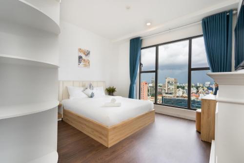a bedroom with a bed and a large window at Saigon Royal Apartment 3 bedrooms 4 beds for 30 nights stay above in Ho Chi Minh City