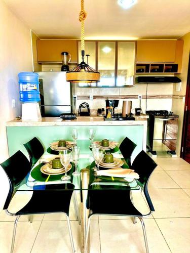 a kitchen with a table with wine glasses on it at Apartamento em Bananeiras in Bananeiras