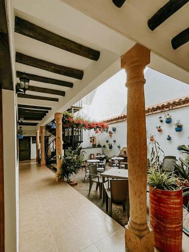 an outdoor patio with tables and chairs and a dining area at Hotel Verona Villa de Leyva in Villa de Leyva