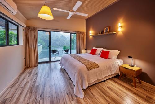 a bedroom with a bed and a large window at Cinnamon House at Vanilla Club in Berner Creek