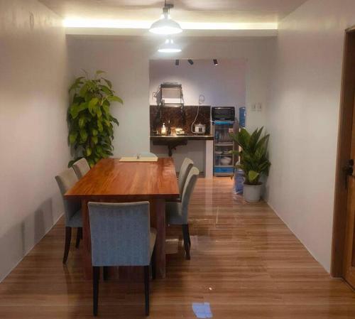 a dining room with a wooden table and chairs at 2 Bedroom, 1 Bathroom Home with street parking in Sibulan