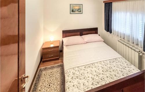 a small bedroom with a bed and a night stand at 1 Bedroom Cozy Apartment In Kukci in Kukci
