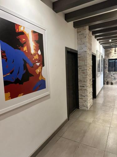a hallway with a large painting on the wall at Quinta del sol in Chihuahua