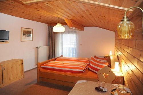 a bedroom with a bed with pillows on it at Pension Waldeck in Langdorf im Landkreis Regen
