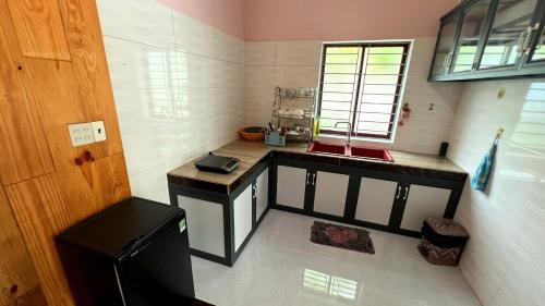 a small kitchen with a sink and a counter at Phu Nam House - Resort in Phu Quoc