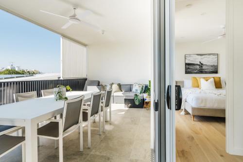 a living room with a bed and a table and chairs at SILK - Lustrous Vacation Awaits 400m to the Beach in Coolum Beach
