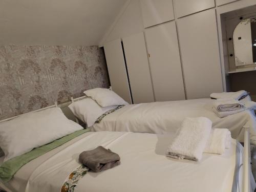 a room with two beds with towels on them at Comfortable 4-Bed House in Hucknall Nottingham in Nottingham