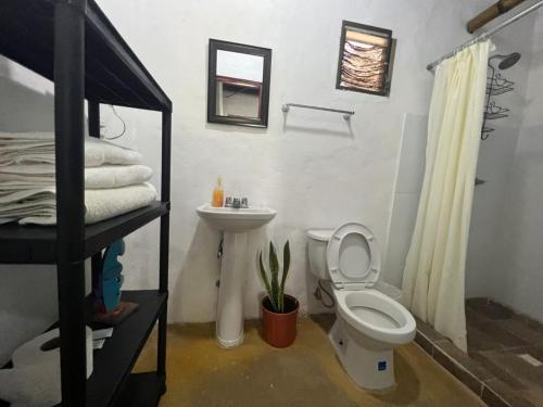 a bathroom with a toilet and a sink at The Blue House Panama in Chame