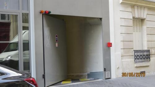 an open door of a building with a car in it at Hôtel de Bellevue Paris Gare du Nord in Paris