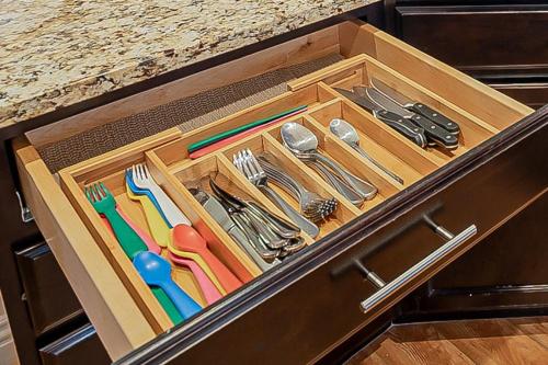 a wooden box with utensils in a drawer at Sports Themed--Automated King Bed--Family Friendly--5 miles to Strip in Henderson