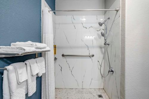 a bathroom with a shower with a glass door at Best Western PLUS Victoria Inn & Suites in Victoria