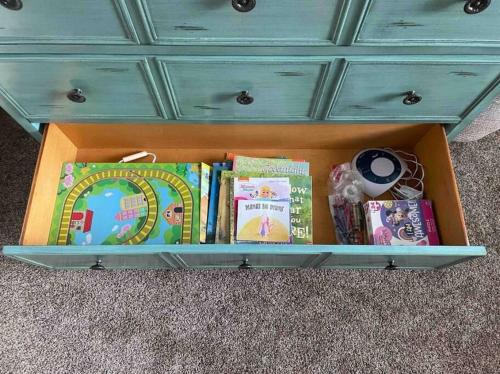 a drawer filled with books and a blue dresser at Villa Grove by Rather Be Properties in Big Bear Lake