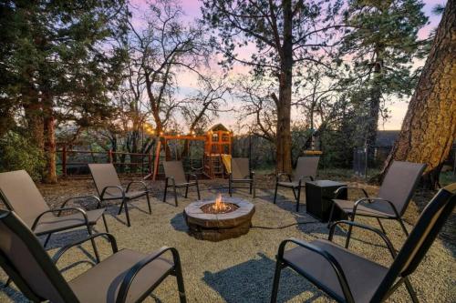 a group of chairs and a fire pit in a yard at Villa Grove by Rather Be Properties in Big Bear Lake