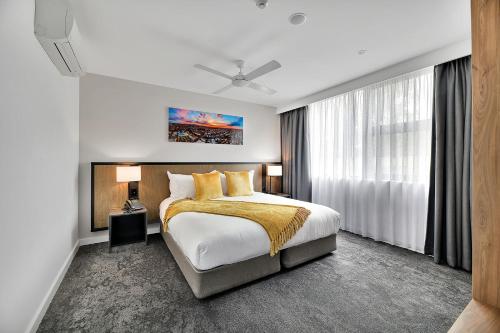 a bedroom with a bed and a large window at The Remington Orange in Orange