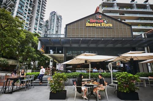 a group of people sitting at tables in front of a building at M Social Singapore in Singapore