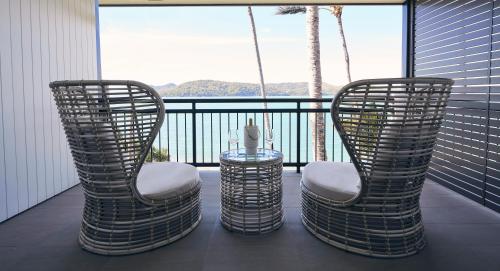 two chairs and a table on a balcony at Daydream Island Resort in Daydream Island
