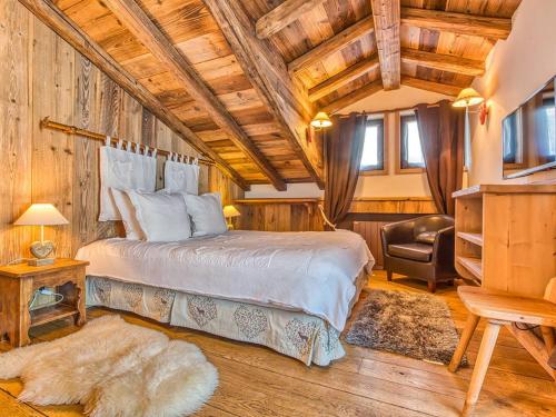 a bedroom with a large bed in a room with wooden ceilings at Appartement de Charme à Courchevel 1850 - 4 pers, Centre, Proche des Pistes, Balcon et Hammam - FR-1-631-163 in Courchevel
