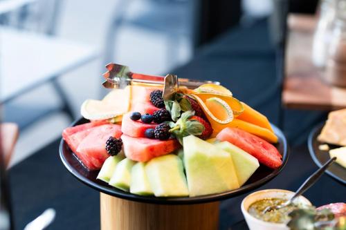 a plate of fruit on a table at The Remington Orange in Orange