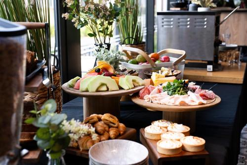a display of different types of food on three plates at The Remington Orange in Orange